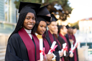 row of entrepreneur graduates holding diplomas