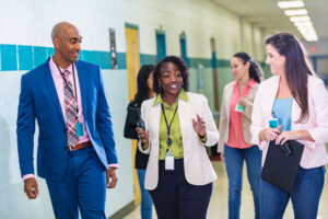 teachers walking in hallway with students