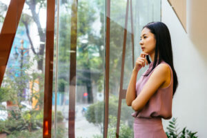 thoughtful woman looking out the window
