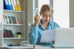 surprised smile at computer