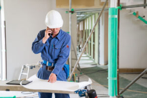 construction worker on phone with boss