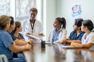 female doctor talking with group of professionals
