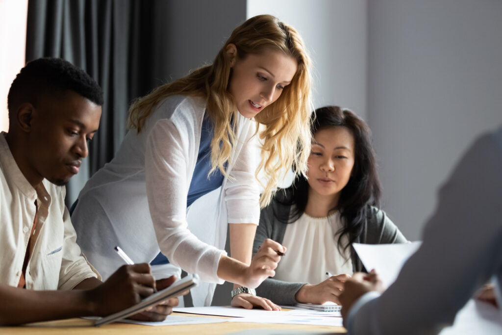 woman leader explaining research results to colleagues