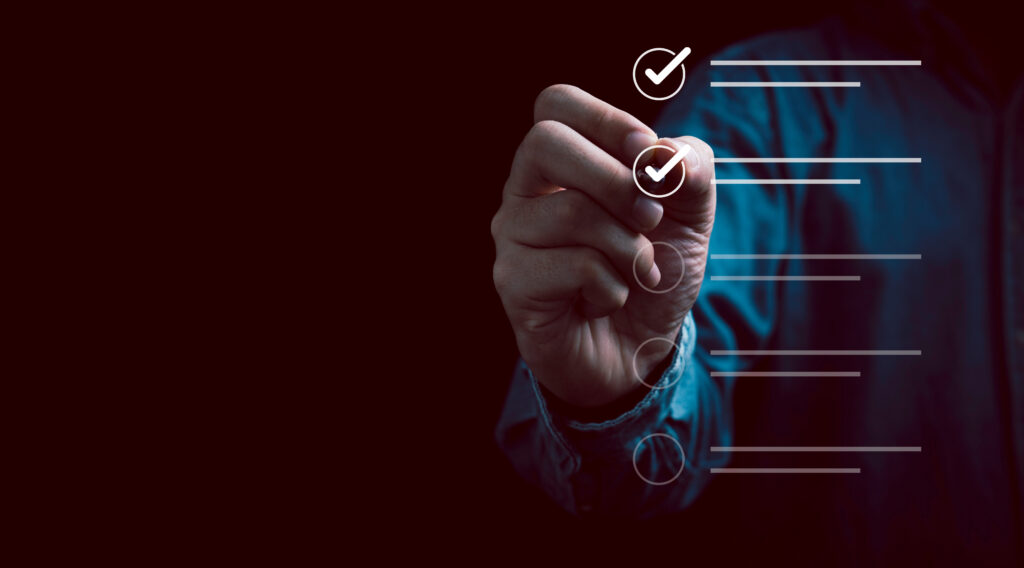 Businessman using pen to tick Checklist.