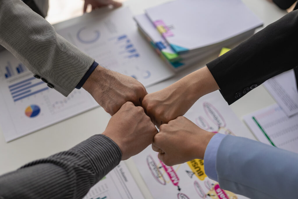 A group of business people join hands to successfully make contact, work as a team to achieve goals, hand-to-hand coordination is a symbol of unity within the organization to strive for success